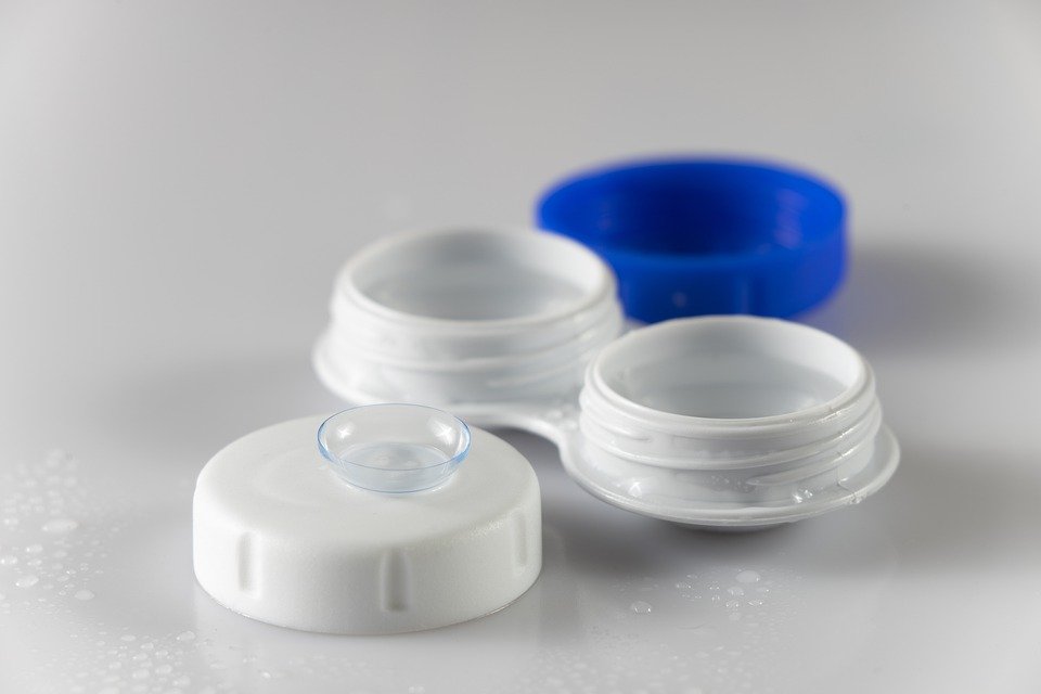 White and blue contact lenses case with a contact lens  