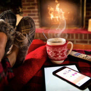 keeping warm and cosy in the winter with slippers and a hot drink in front of a fireplace