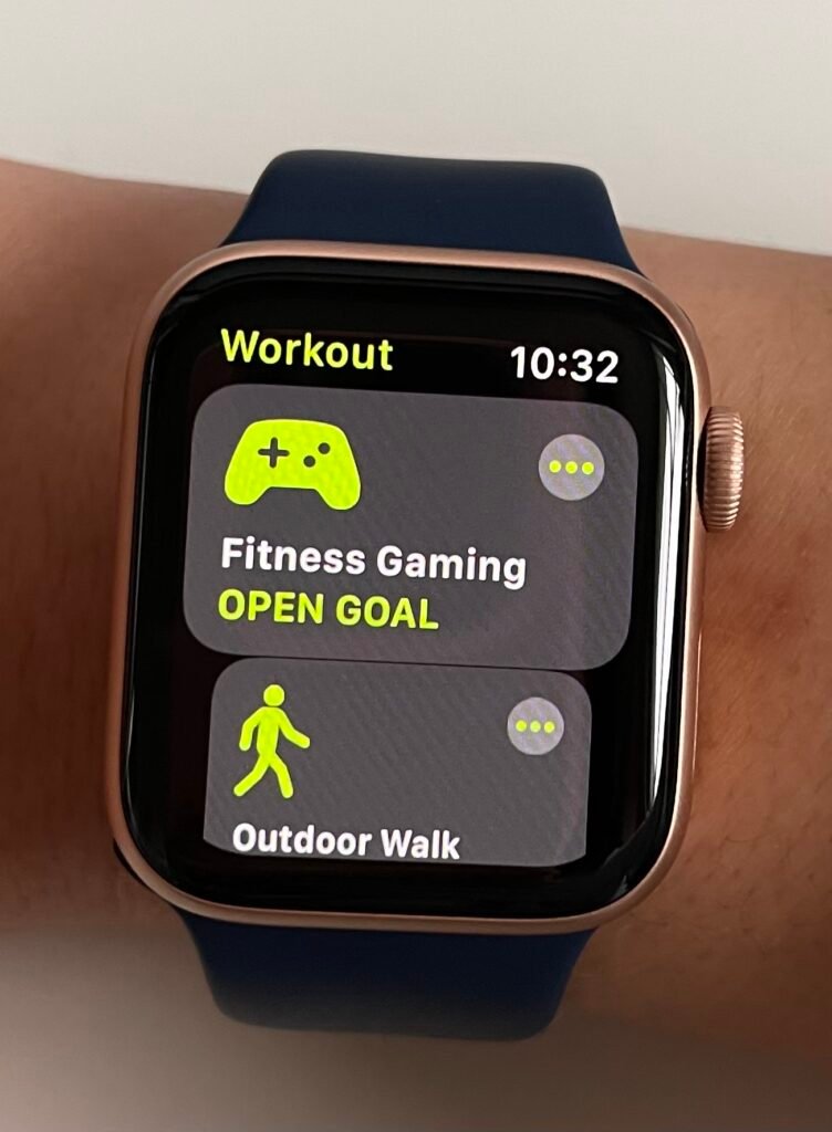 Apple watch series 6 in gold with navy blue sports strap. The apple watch can track your Nintendo Ring Fit Adventure using Fintess Gaming under workout.