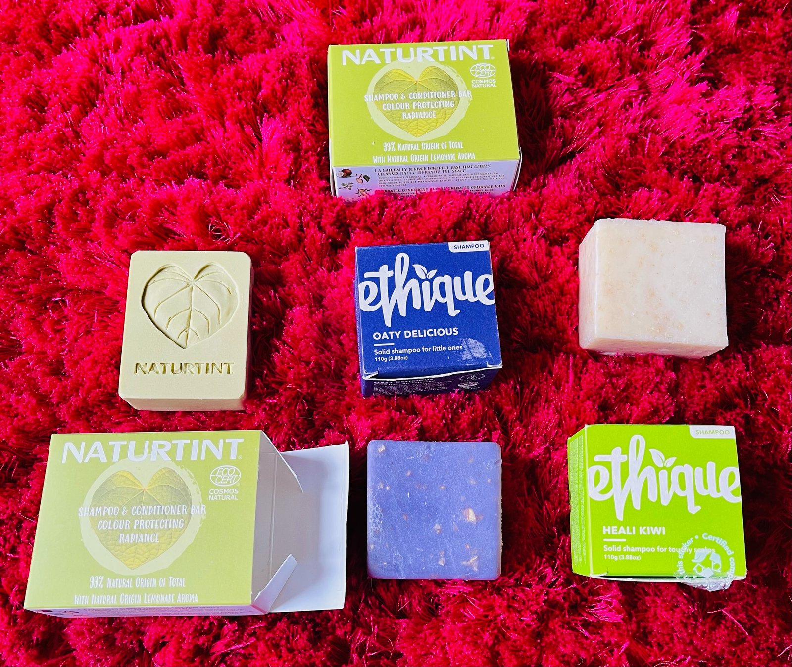 Naturtint and ethique zero-waste, natural solid shampoo bars for adults and kids on red fluffy rug