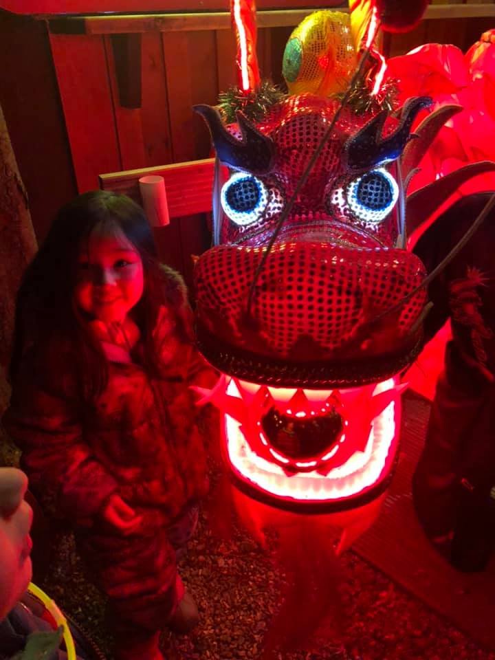 Yasmin next to a red glowing chinese dragon at robin hills spirit of the orient event for chinese new year. 
