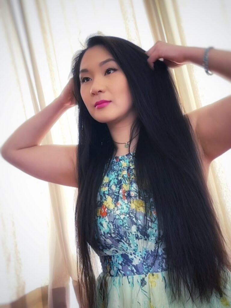 lei hang in a green floral maxi dress playing with her long straight black hair for a virtual photoshoot 