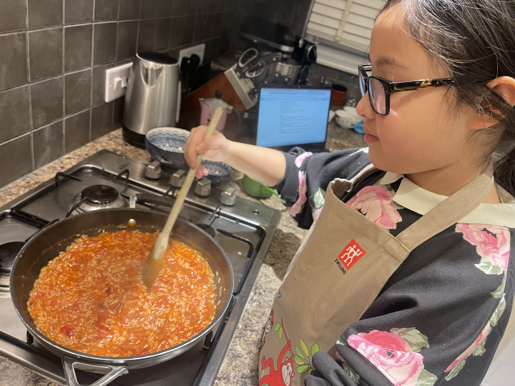 Cook Dinner With The Kids for Father’s Day! 

Lei Hang's daughter Yasmin cooking paella. - The Thrifty Island Girl